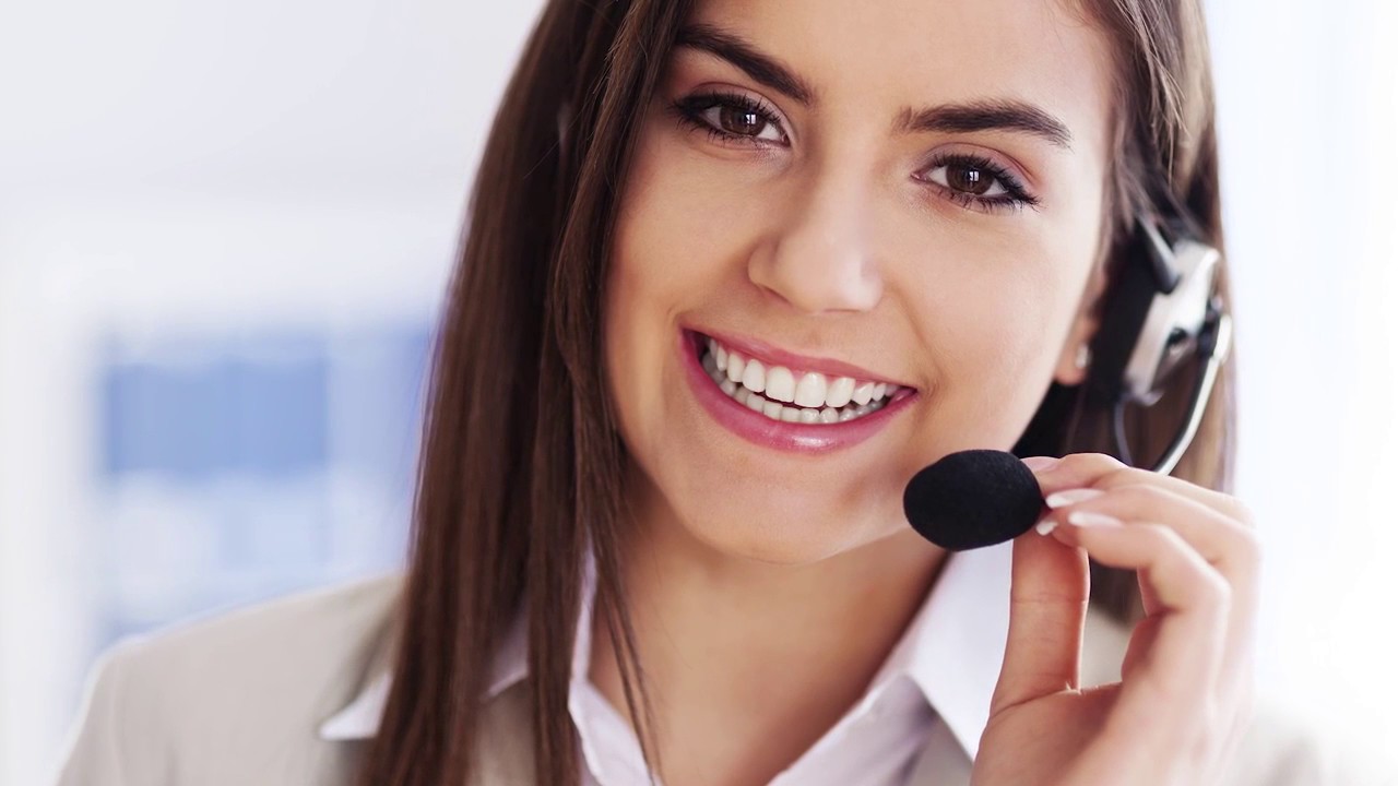 Image of a woman wearing a telephone headset indicating contact Liebherr.